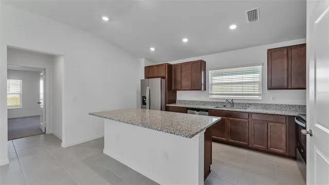 a kitchen with stainless steel appliances granite countertop a sink and a granite counter tops