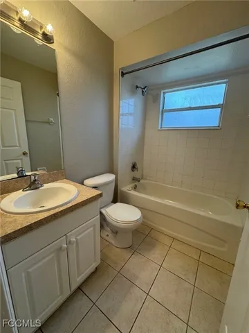 a bathroom with a granite countertop sink toilet a mirror and shower