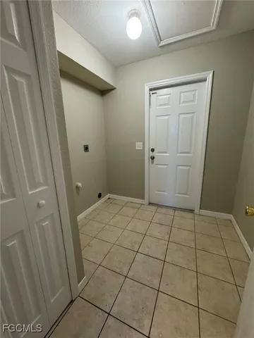 a room with a wooden floor and washing machine in a room