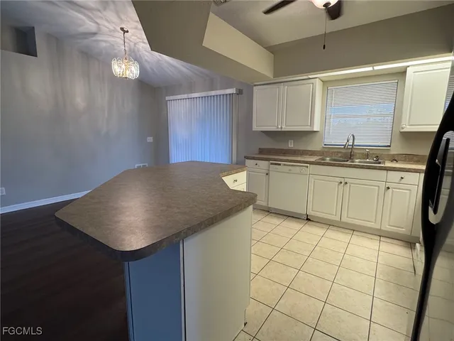a kitchen with stainless steel appliances granite countertop a sink and a stove