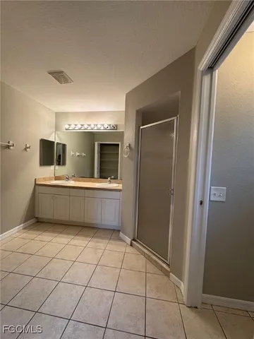 a view of an empty room with cabinet and a window