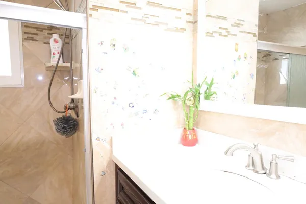 a bathroom with a shower and a sink