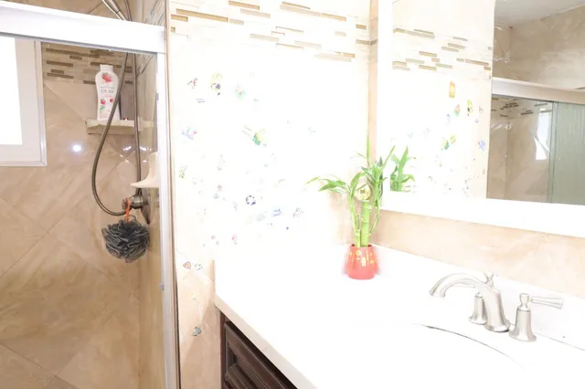 a bathroom with a shower and a sink