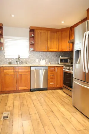 a dining room with furniture and wooden floor