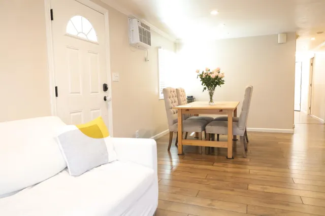 a dining room with furniture and wooden floor