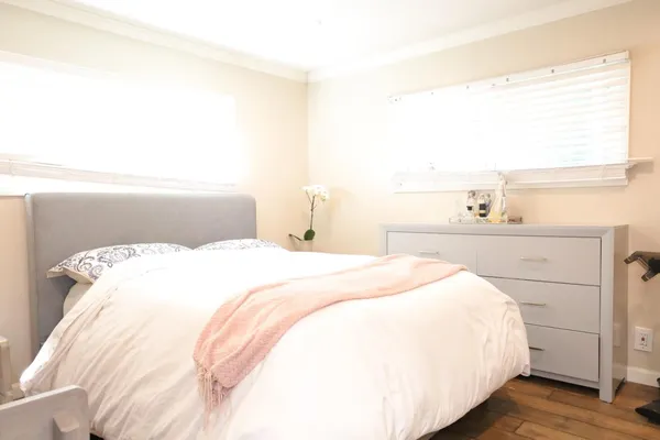 a bedroom with a bed and a book shelf