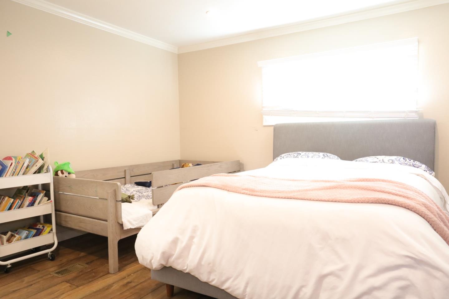 191 East El Camino Real, Unit 138 Mountain View, CA 94040 - Photo 8 of 23 a bedroom with a bed and a book shelf