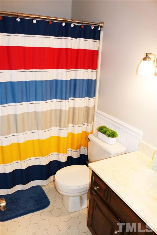 4508 Tetbury Place Raleigh, NC 27613 - Photo 19 of 22 a bathroom with a sink a bathtub and a shower