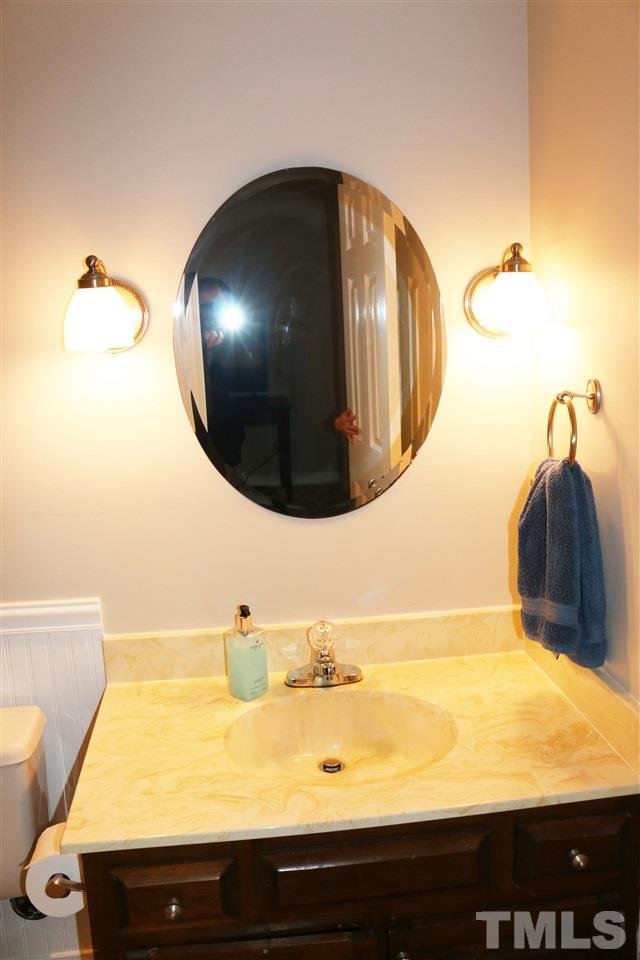 4508 Tetbury Place Raleigh, NC 27613 - Photo 20 of 22 a bathroom with a sink and a mirror