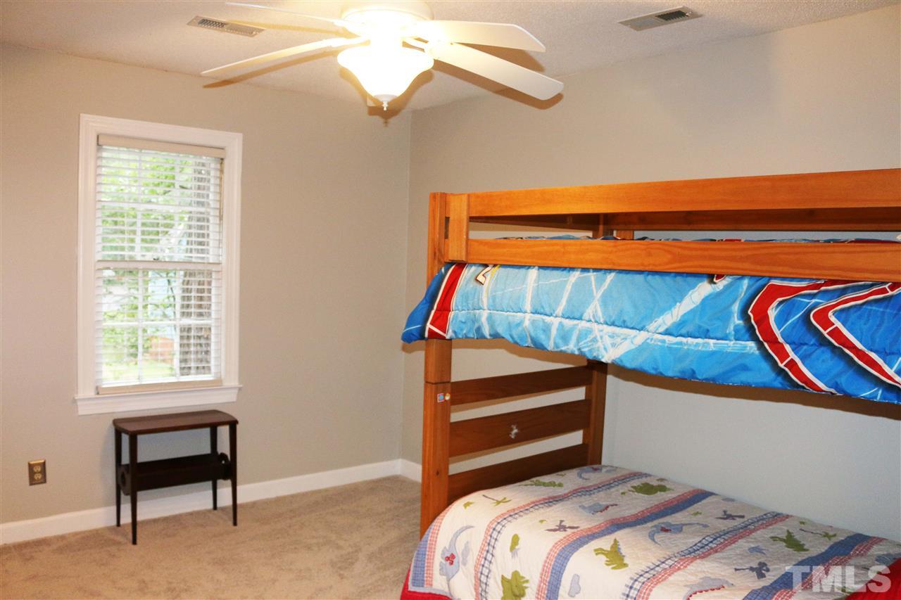 4508 Tetbury Place Raleigh, NC 27613 - Photo 21 of 22 a bedroom with a bed and a window