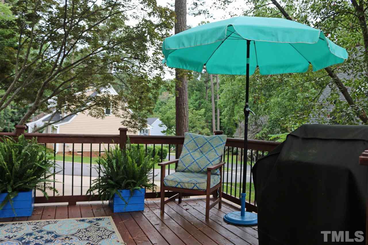 4508 Tetbury Place Raleigh, NC 27613 - Photo 4 of 22 a view of a deck with furniture and barbeque oven in the backyard
