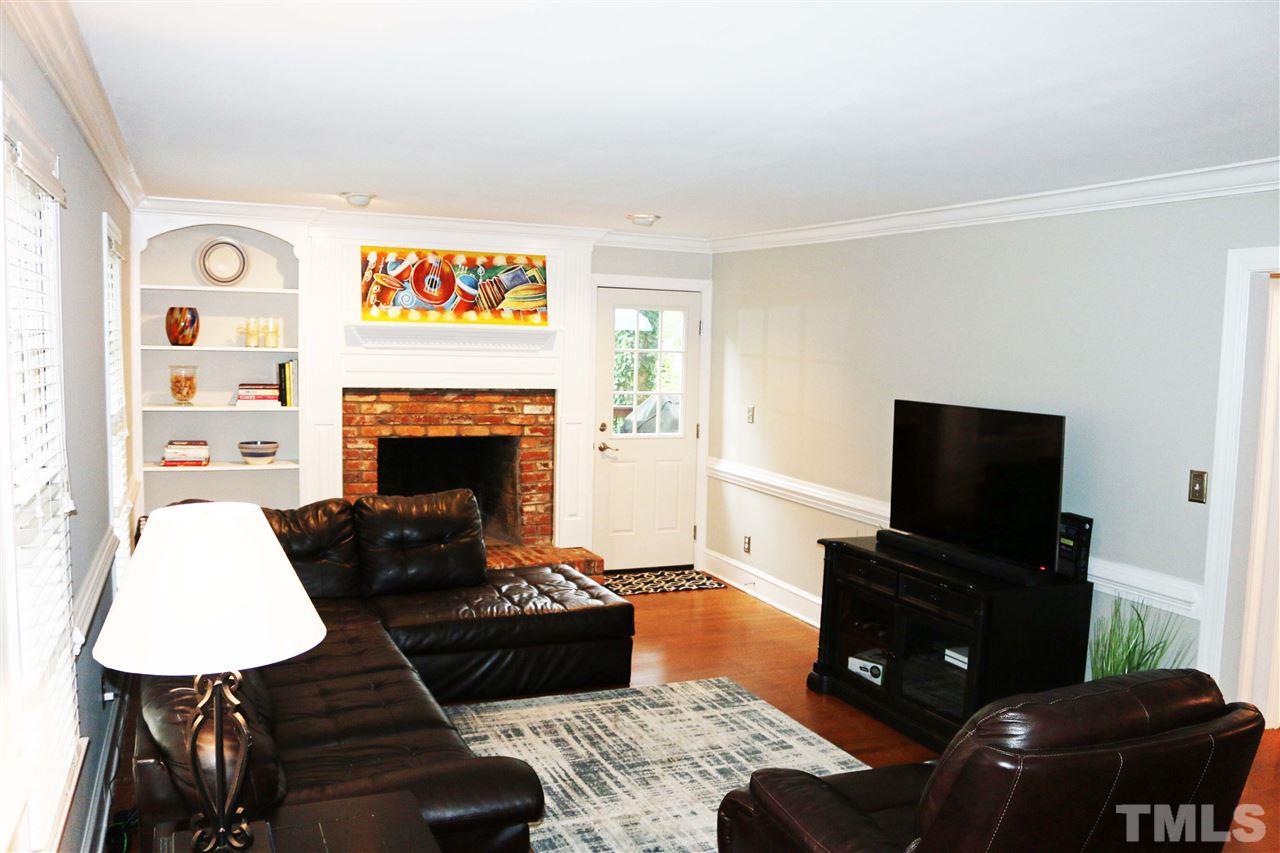 4508 Tetbury Place Raleigh, NC 27613 - Photo 6 of 22 a living room with furniture and a fireplace