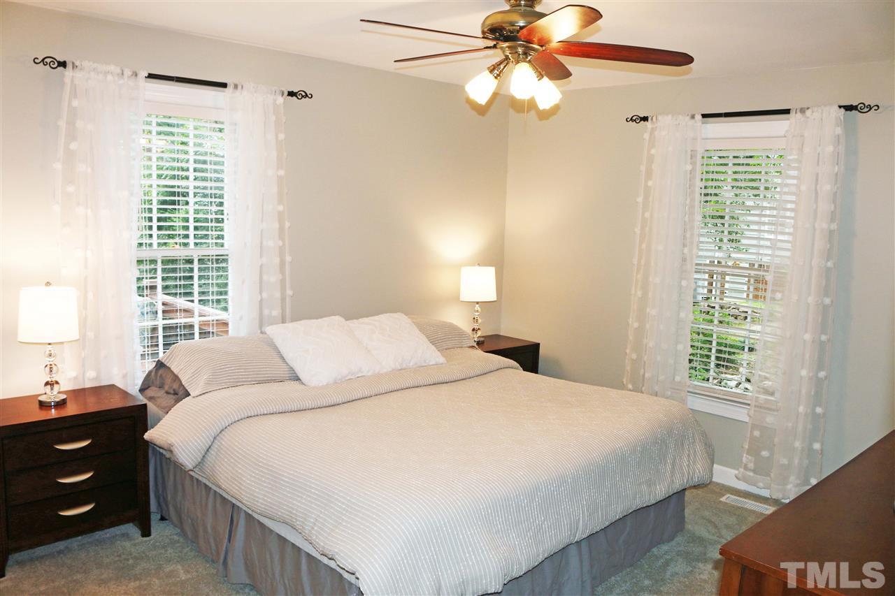 4508 Tetbury Place Raleigh, NC 27613 - Photo 8 of 22 a bedroom with a bed and a window