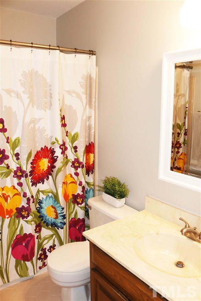 4508 Tetbury Place Raleigh, NC 27613 - Photo 10 of 22 a bathroom with a sink mirror vanity and toilet
