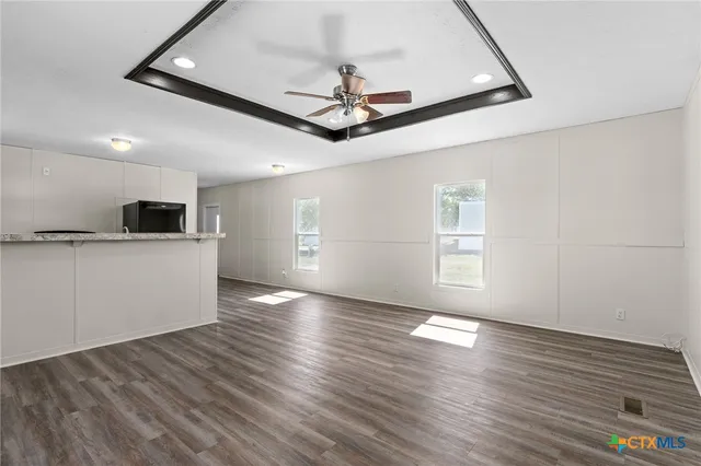 a view of a kitchen with a stove wooden floor and a kitchen space