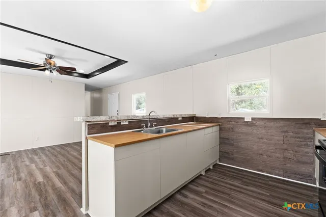 a kitchen with sink cabinets and window