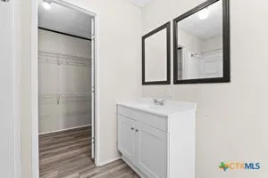 a bathroom with a sink a mirror and a shower