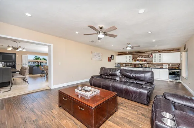 a living room with furniture and wooden floor