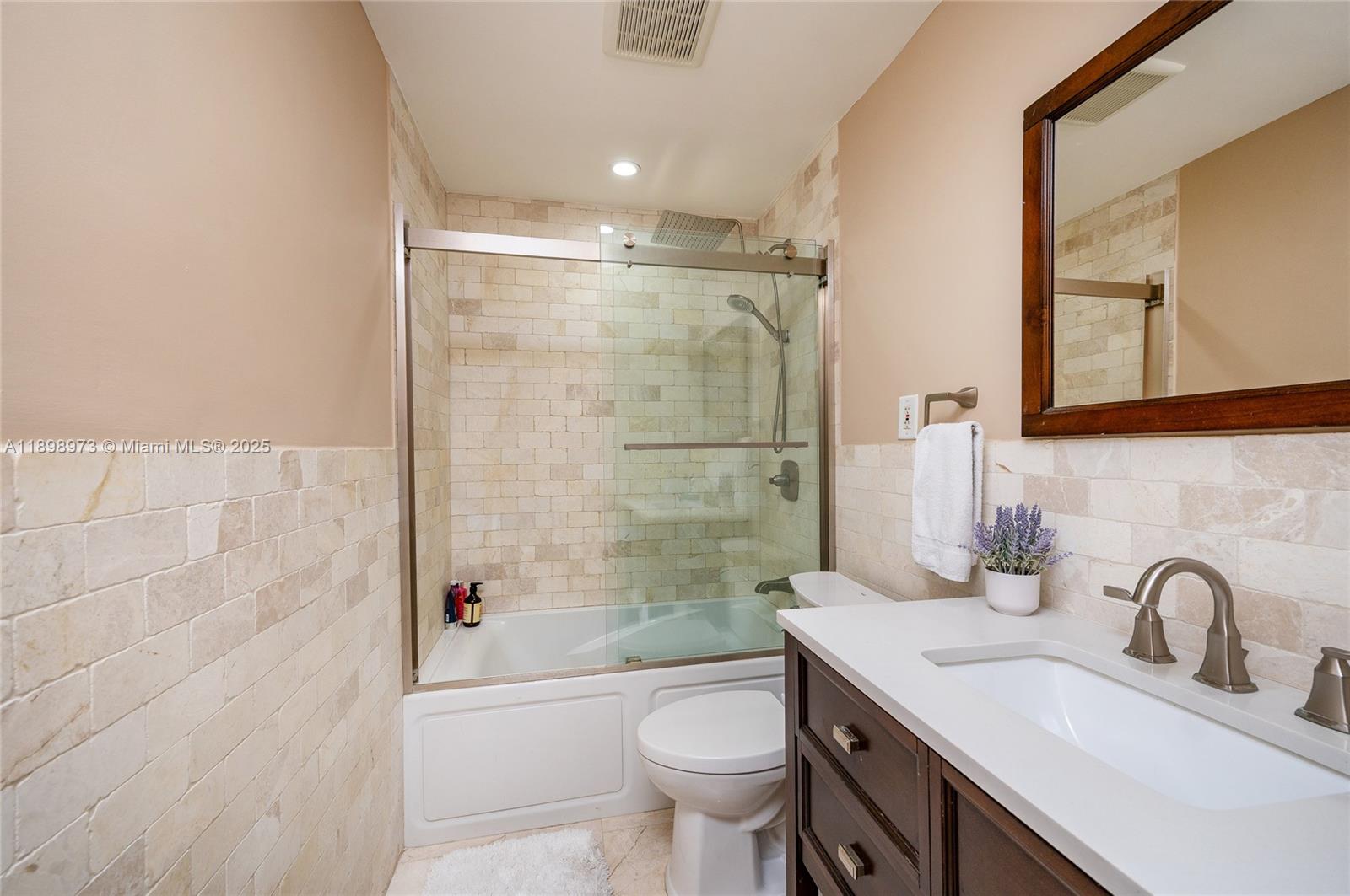10341 Southwest 52nd Terrace Miami, FL 33165 - Photo 17 of 32 a bathroom with a granite countertop sink a toilet and shower