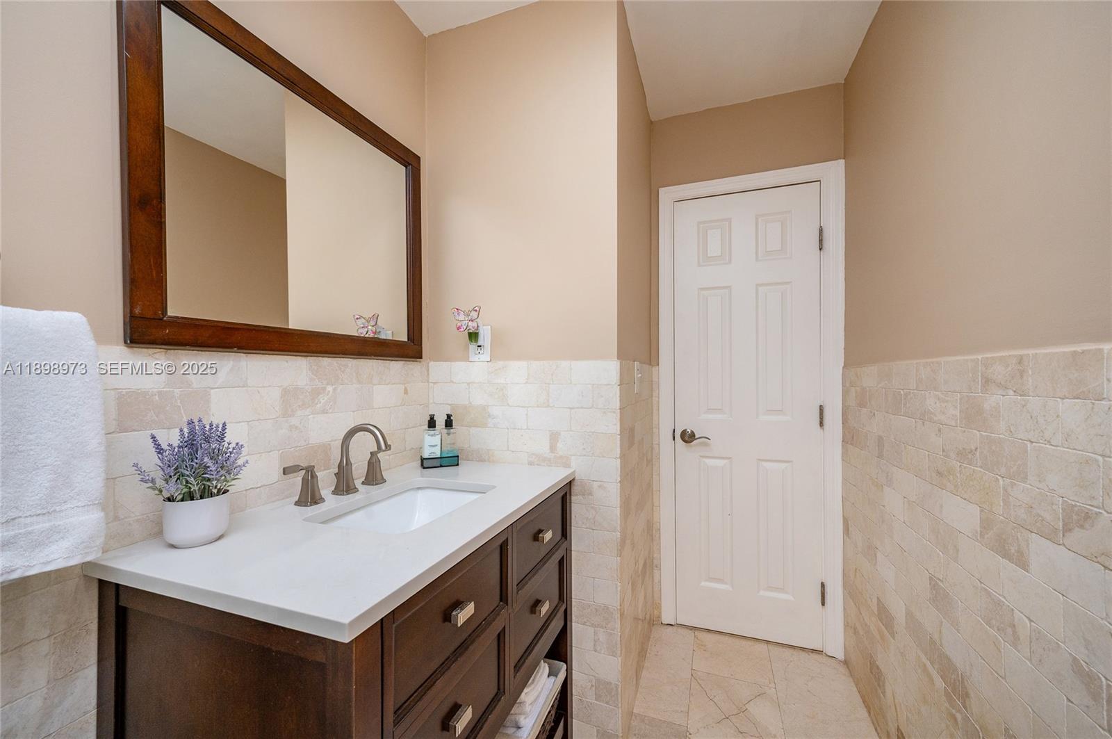 10341 Southwest 52nd Terrace Miami, FL 33165 - Photo 18 of 32 a bathroom with a sink and a mirror