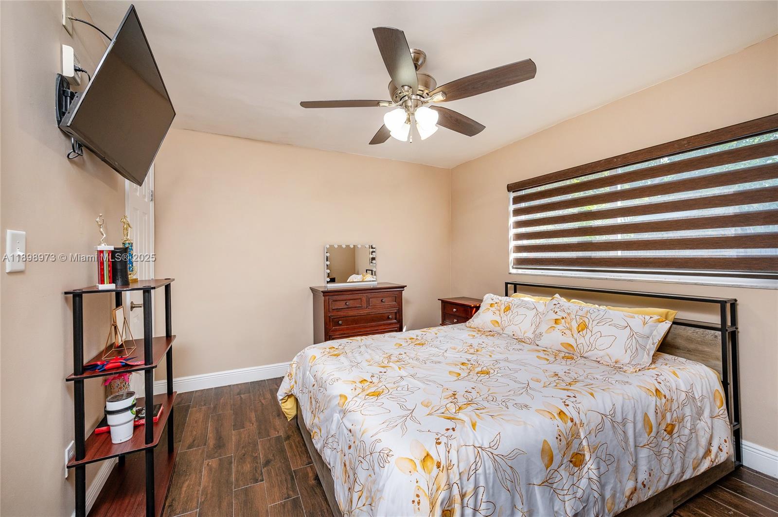 10341 Southwest 52nd Terrace Miami, FL 33165 - Photo 19 of 32 a bedroom with a bed and a flat screen tv