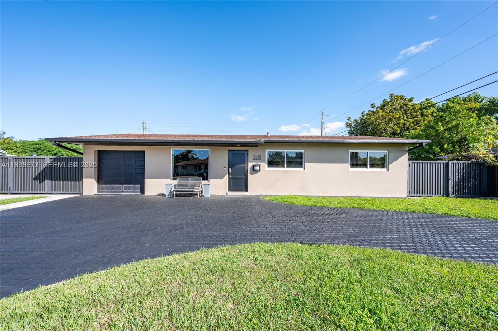 10341 Southwest 52nd Terrace Miami, FL 33165 - Photo 2 of 32 front view of a house with a yard
