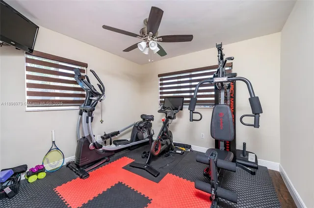 a room with gym equipment and windows