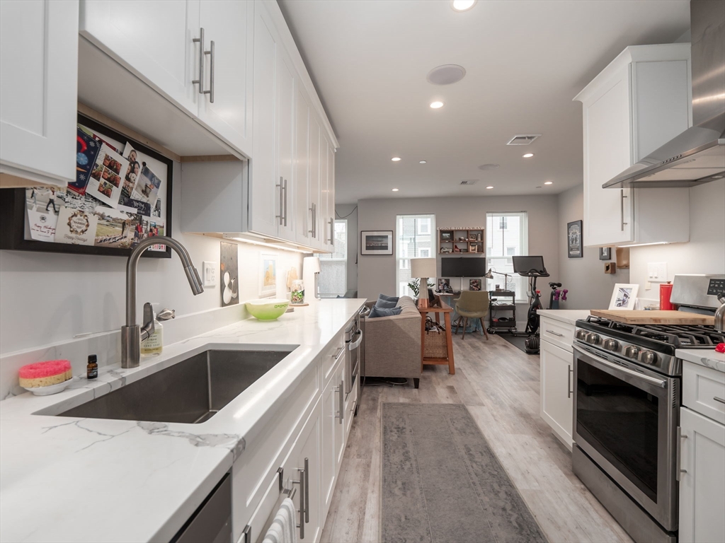 45 L Street, Unit 2 Boston, MA 02127 - Photo 13 of 31 a kitchen with a stove a sink and a refrigerator