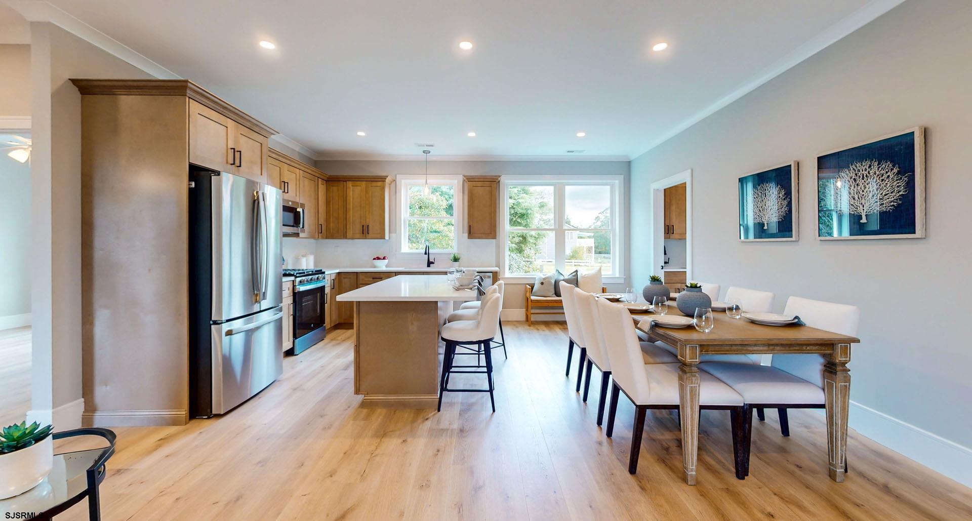 1729 Shore Road Ocean View, NJ 08230 - Photo 13 of 36 a kitchen with sink a refrigerator and chairs