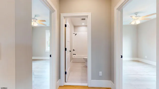 a view of a bathroom from a corridor