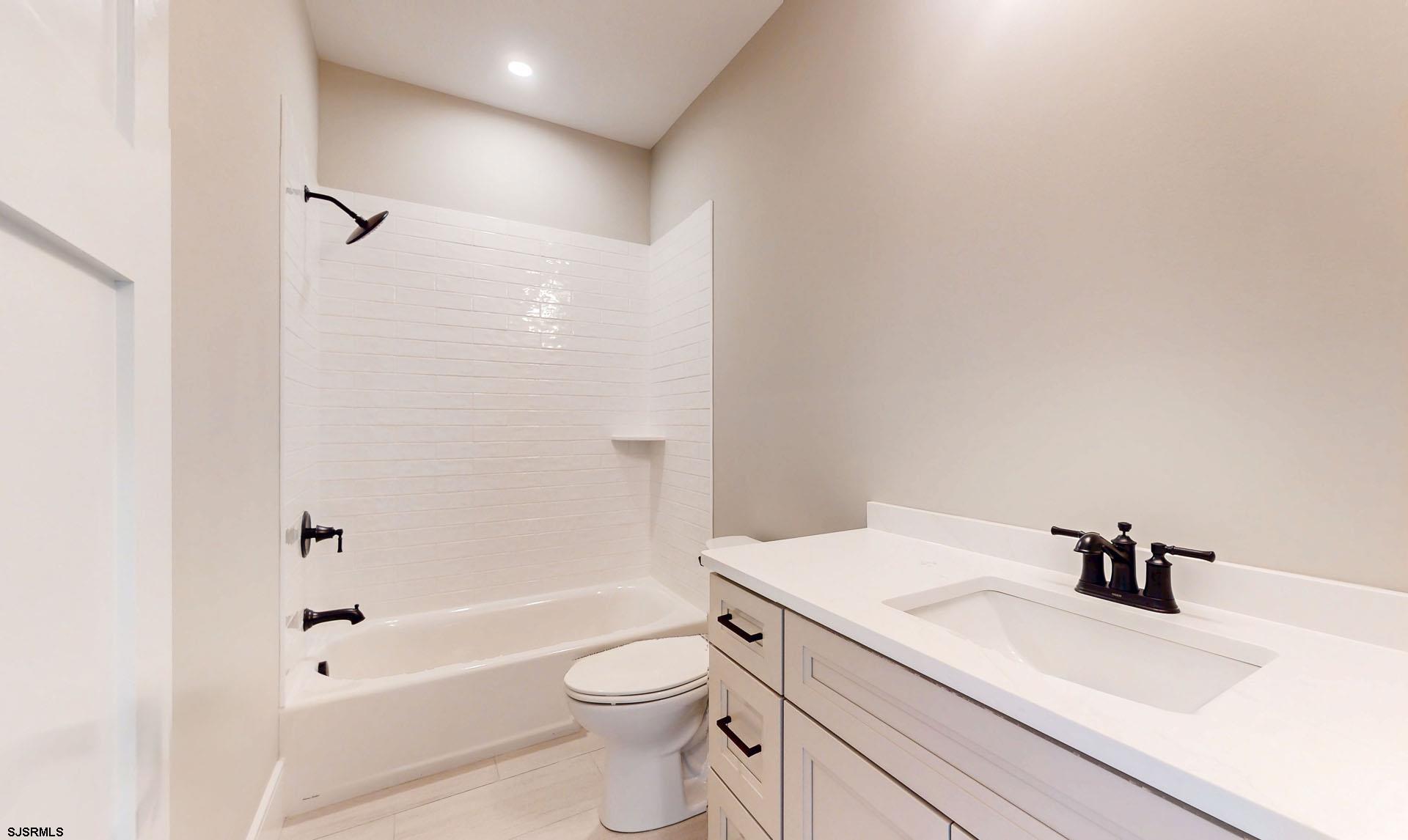 1729 Shore Road Ocean View, NJ 08230 - Photo 19 of 36 a bathroom with a sink a toilet and shower