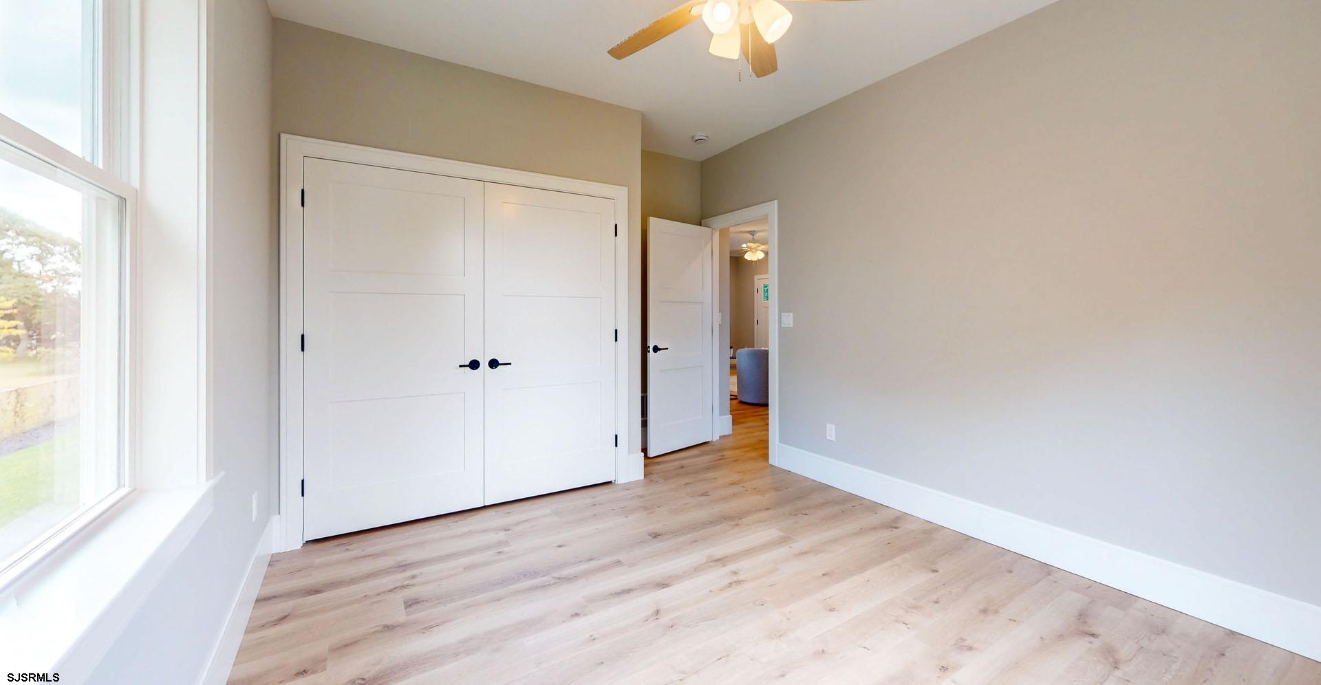 1729 Shore Road Ocean View, NJ 08230 - Photo 23 of 36 wooden floor in an empty room with a window