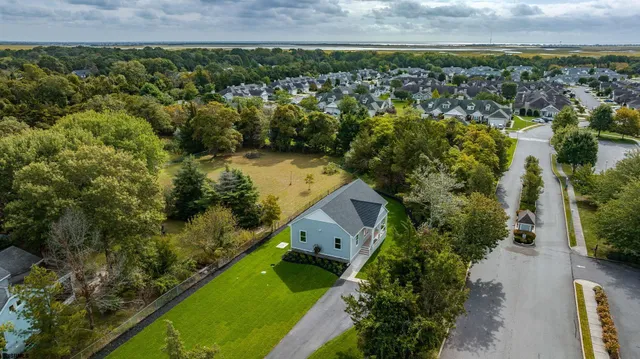 an aerial view of a house with a yard