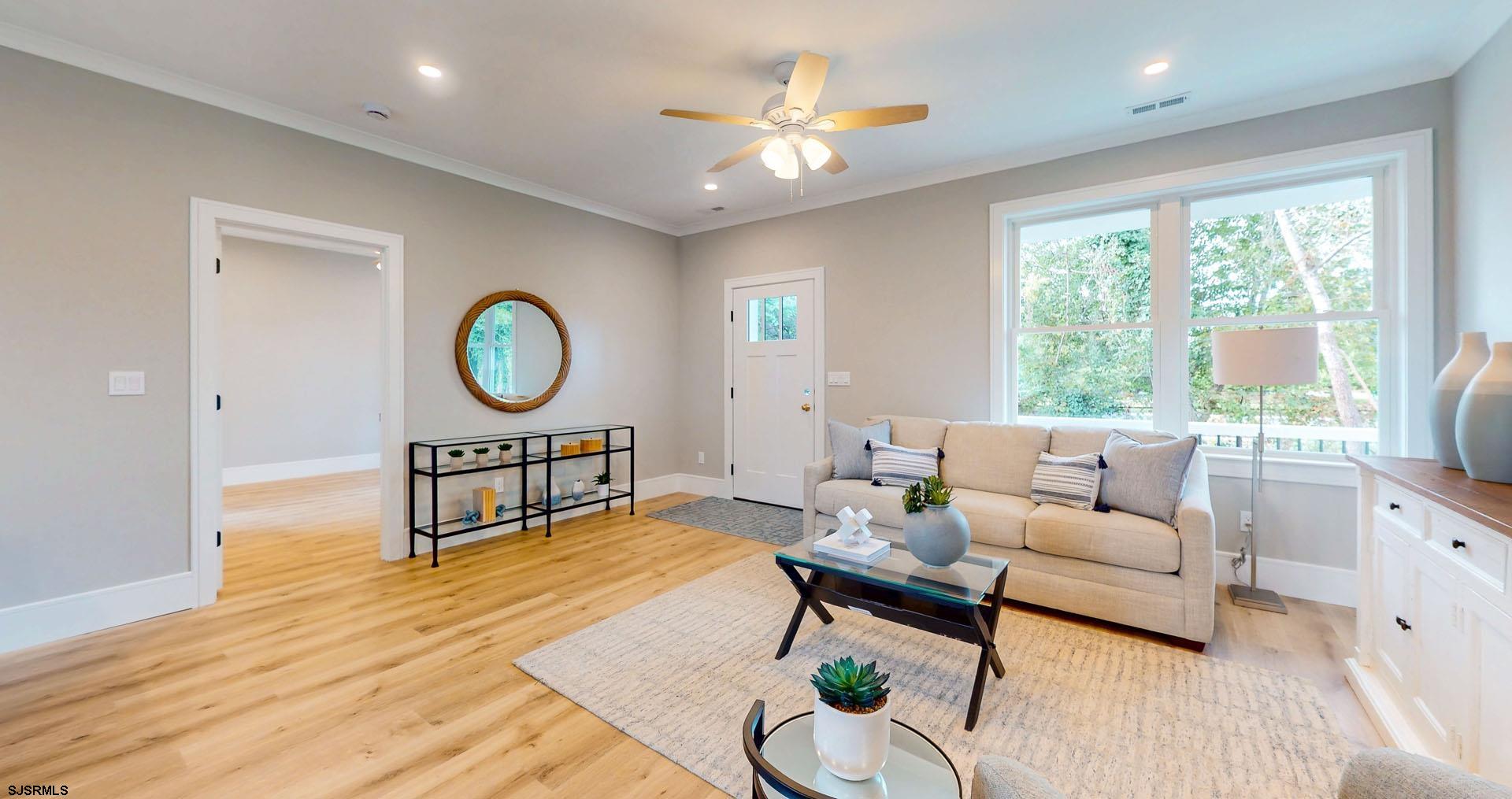 1729 Shore Road Ocean View, NJ 08230 - Photo 6 of 36 a living room with furniture a rug potted plant and a large window