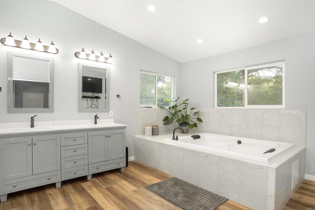 26352 Eagle Gap Road Santa Ysabel, CA 92070 - Photo 11 of 52 a bathroom with a double vanity sink mirror and bathtub