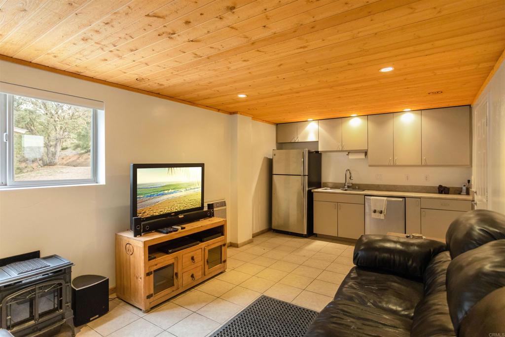 26352 Eagle Gap Road Santa Ysabel, CA 92070 - Photo 28 of 52 a living room with furniture and a flat screen tv