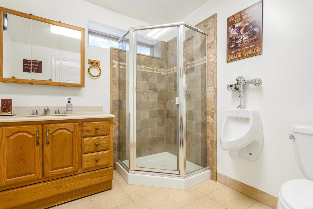 26352 Eagle Gap Road Santa Ysabel, CA 92070 - Photo 29 of 52 a bathroom with a granite countertop sink mirror and shower