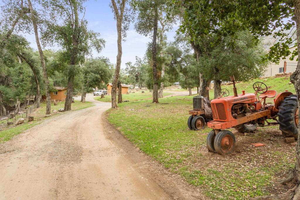 26352 Eagle Gap Road Santa Ysabel, CA 92070 - Photo 32 of 52 a view of a backyard with table and chairs a fire pit and large trees