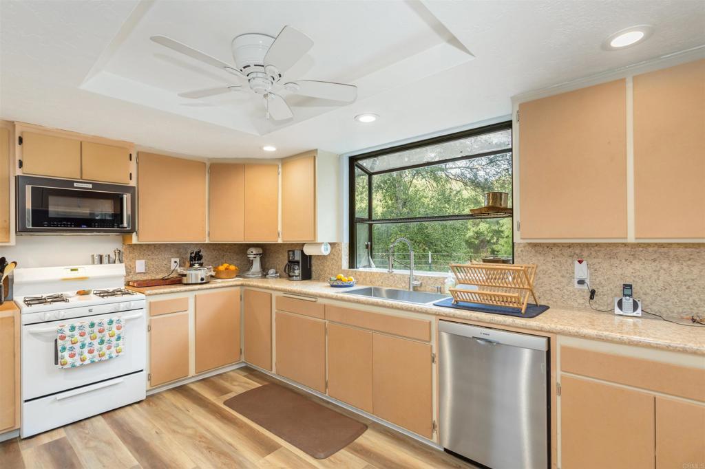 26352 Eagle Gap Road Santa Ysabel, CA 92070 - Photo 7 of 52 a kitchen with a sink window and stainless steel appliances