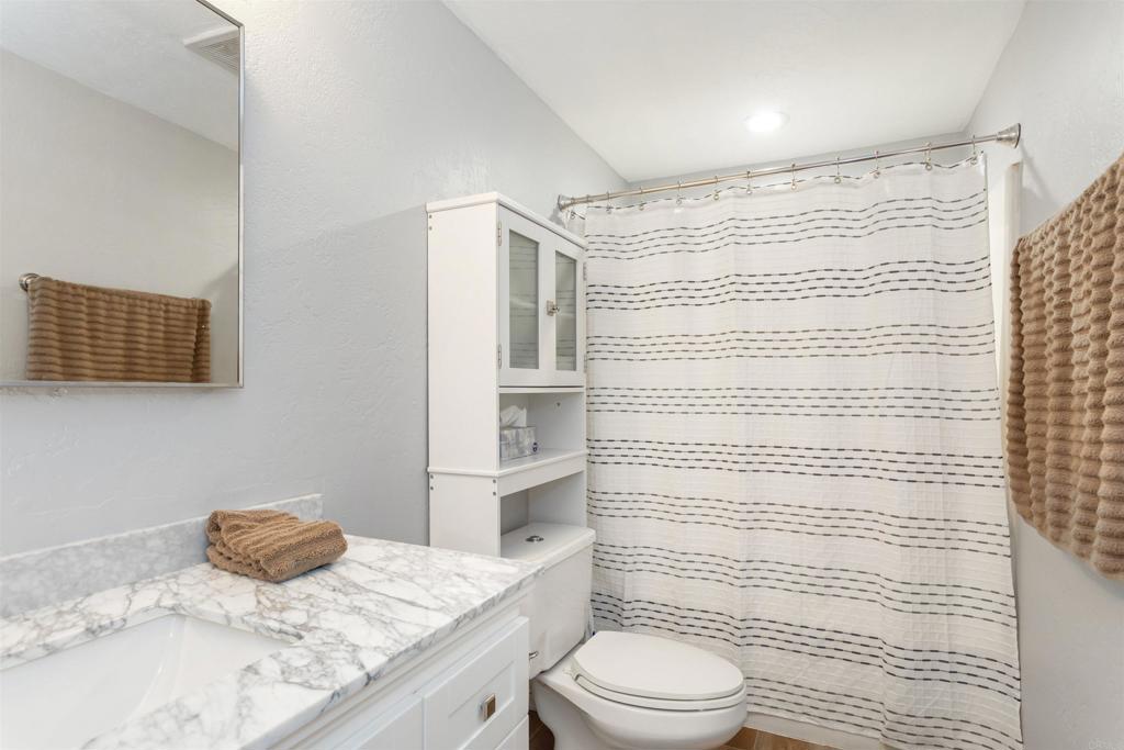 26352 Eagle Gap Road Santa Ysabel, CA 92070 - Photo 9 of 52 a bathroom with a granite countertop sink toilet and shower