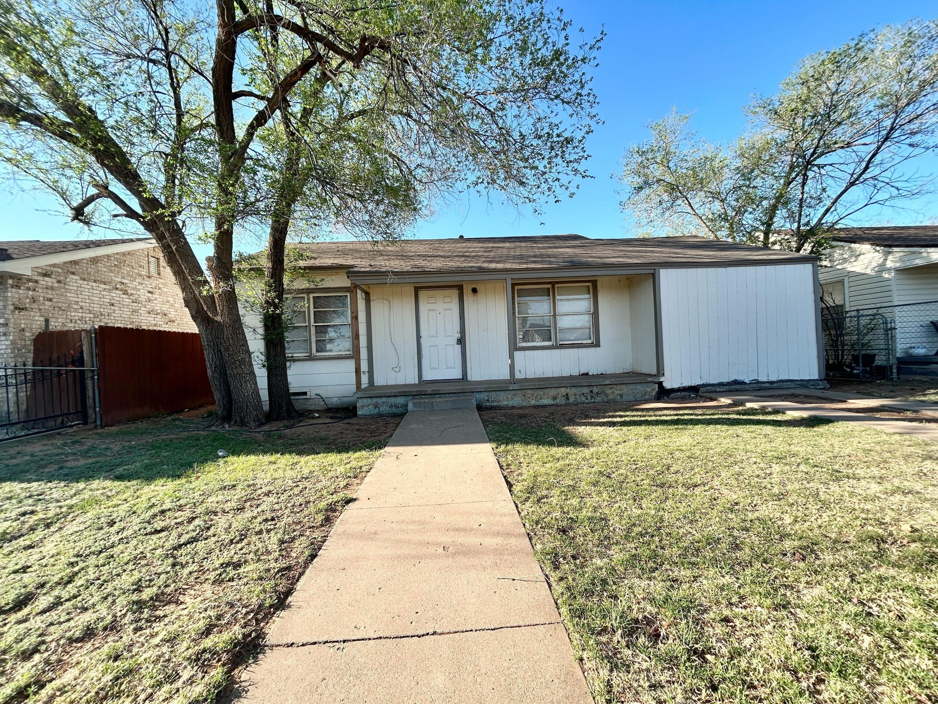 a view of house with backyard space