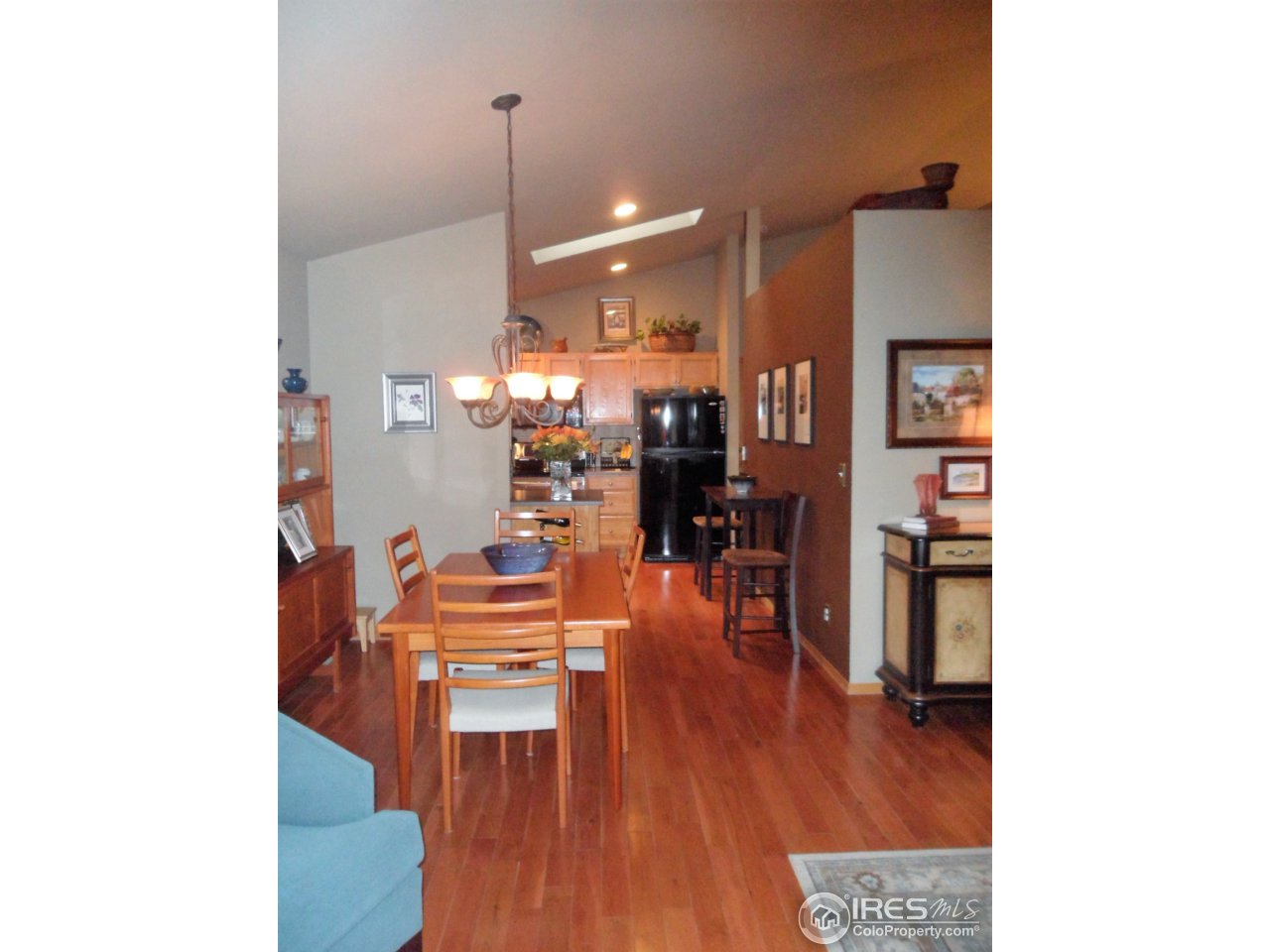 724 Wade Road Longmont, CO 80503 - Photo 11 of 32 a dining room with furniture and wooden floor