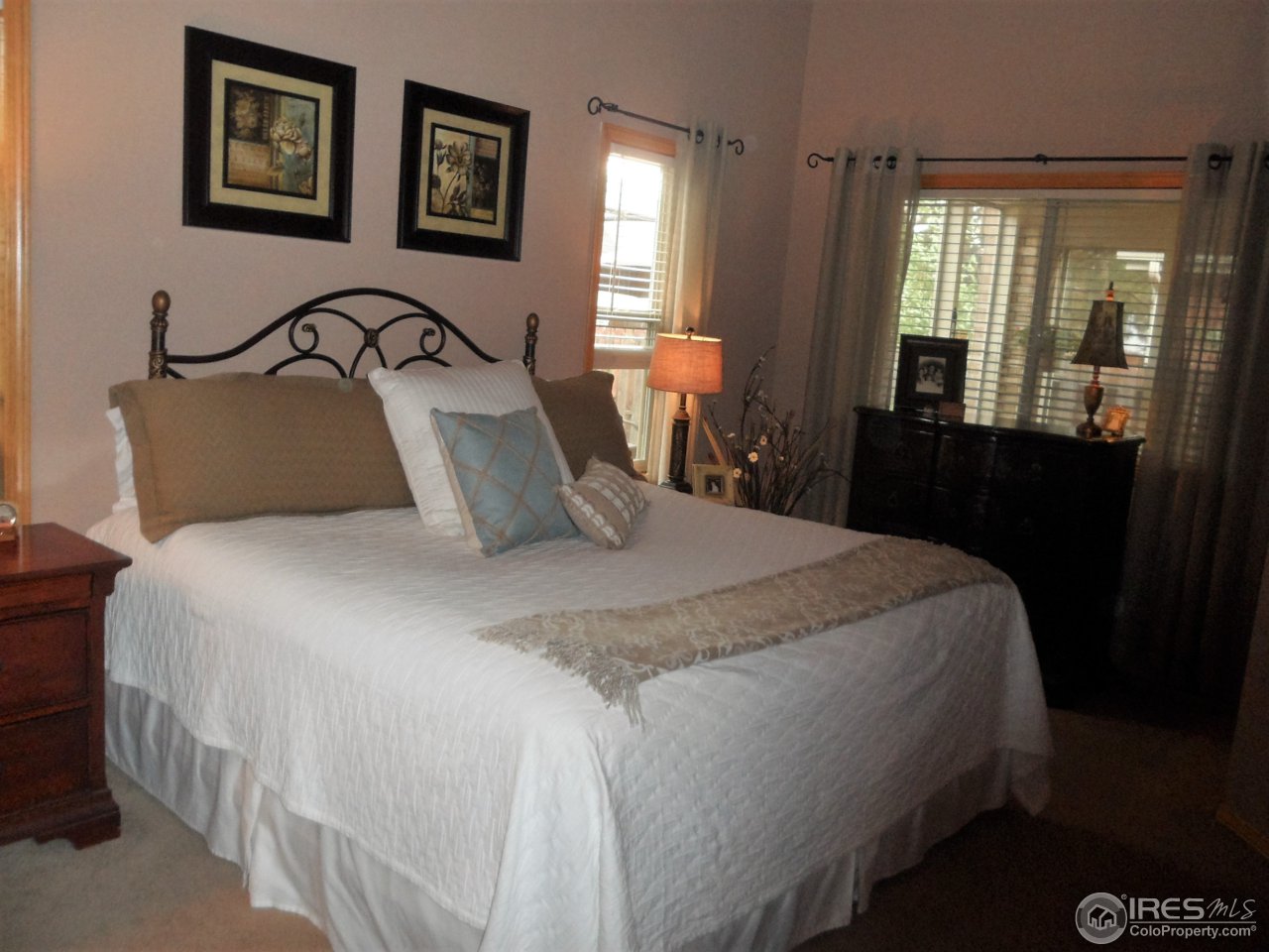 724 Wade Road Longmont, CO 80503 - Photo 12 of 32 a bedroom with a bed and window