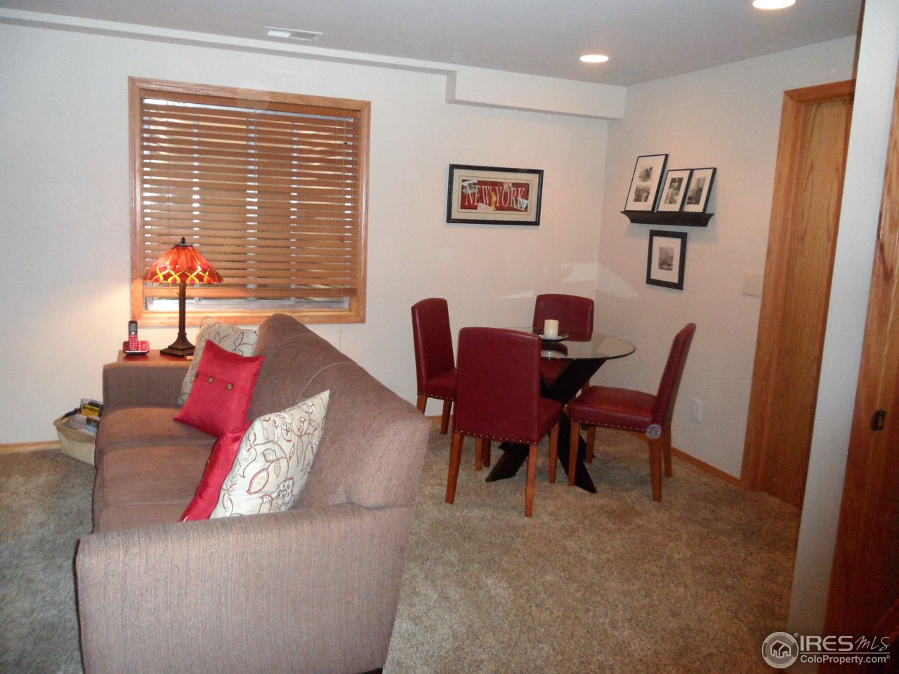 724 Wade Road Longmont, CO 80503 - Photo 19 of 32 a living room with furniture and a window