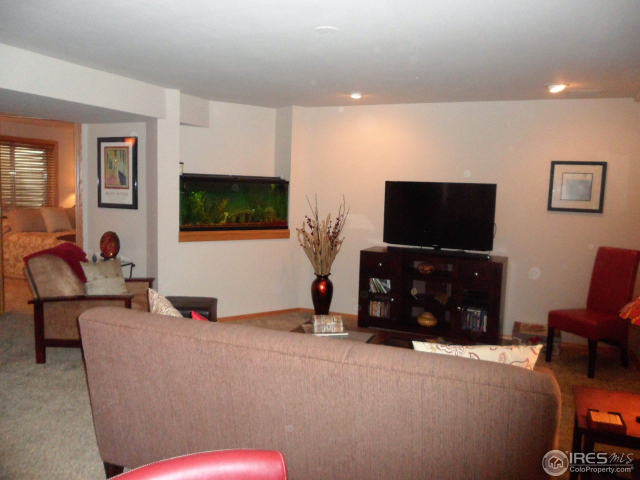 724 Wade Road Longmont, CO 80503 - Photo 20 of 32 a living room with furniture and a flat screen tv