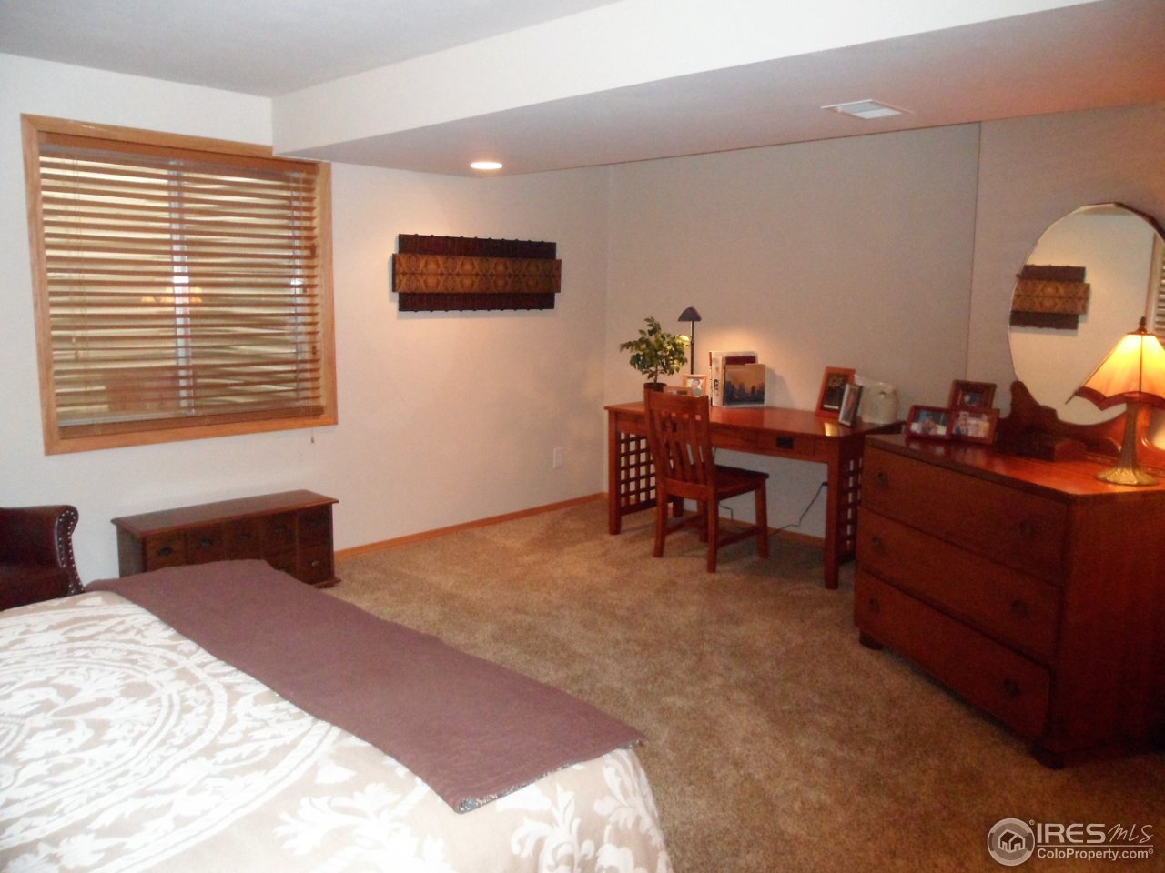 724 Wade Road Longmont, CO 80503 - Photo 23 of 32 a bedroom with a bed and a desk