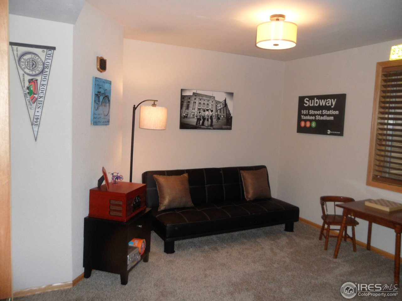 724 Wade Road Longmont, CO 80503 - Photo 24 of 32 a living room with furniture and a window