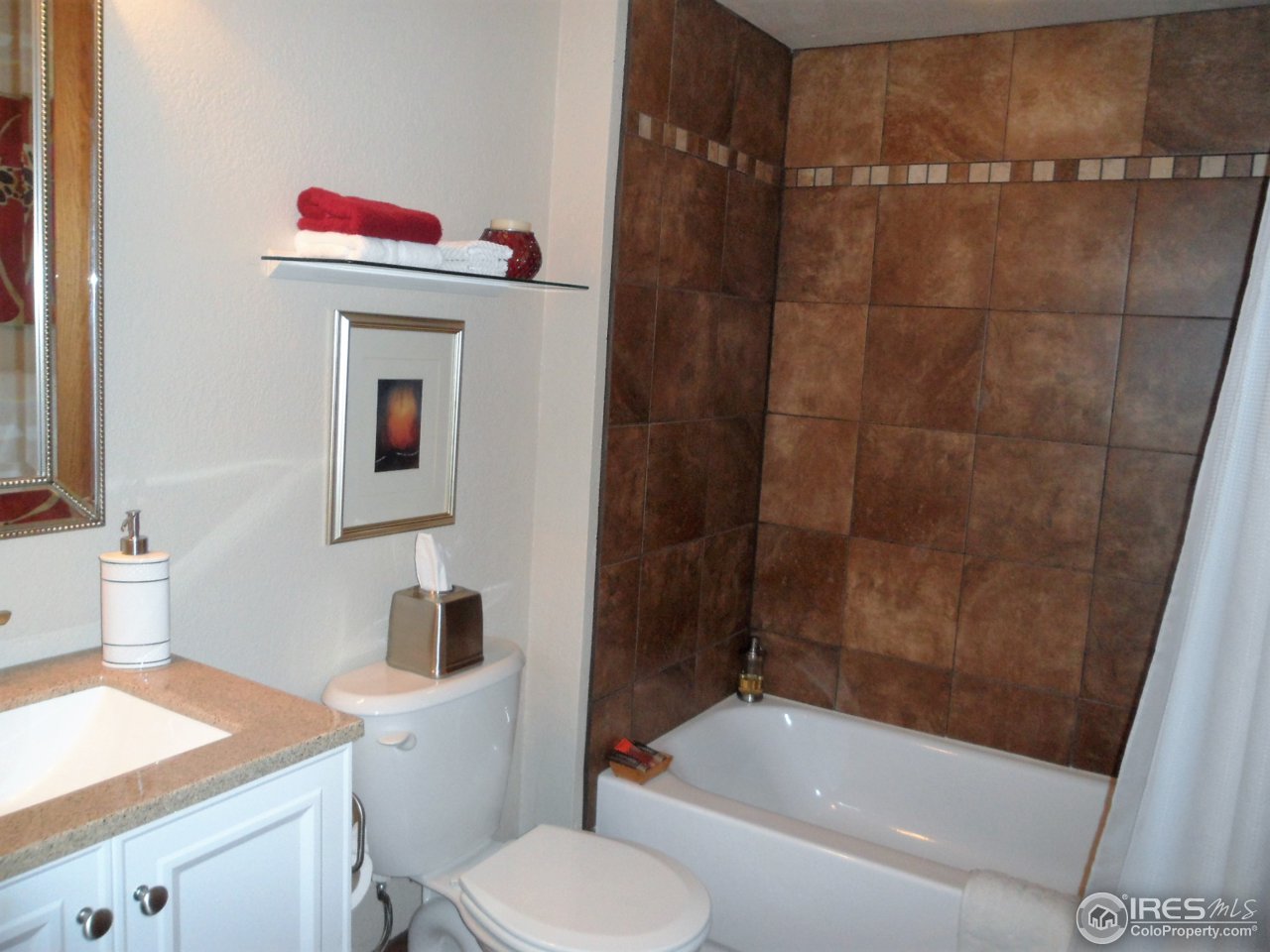 724 Wade Road Longmont, CO 80503 - Photo 25 of 32 a bathroom with a sink toilet and shower