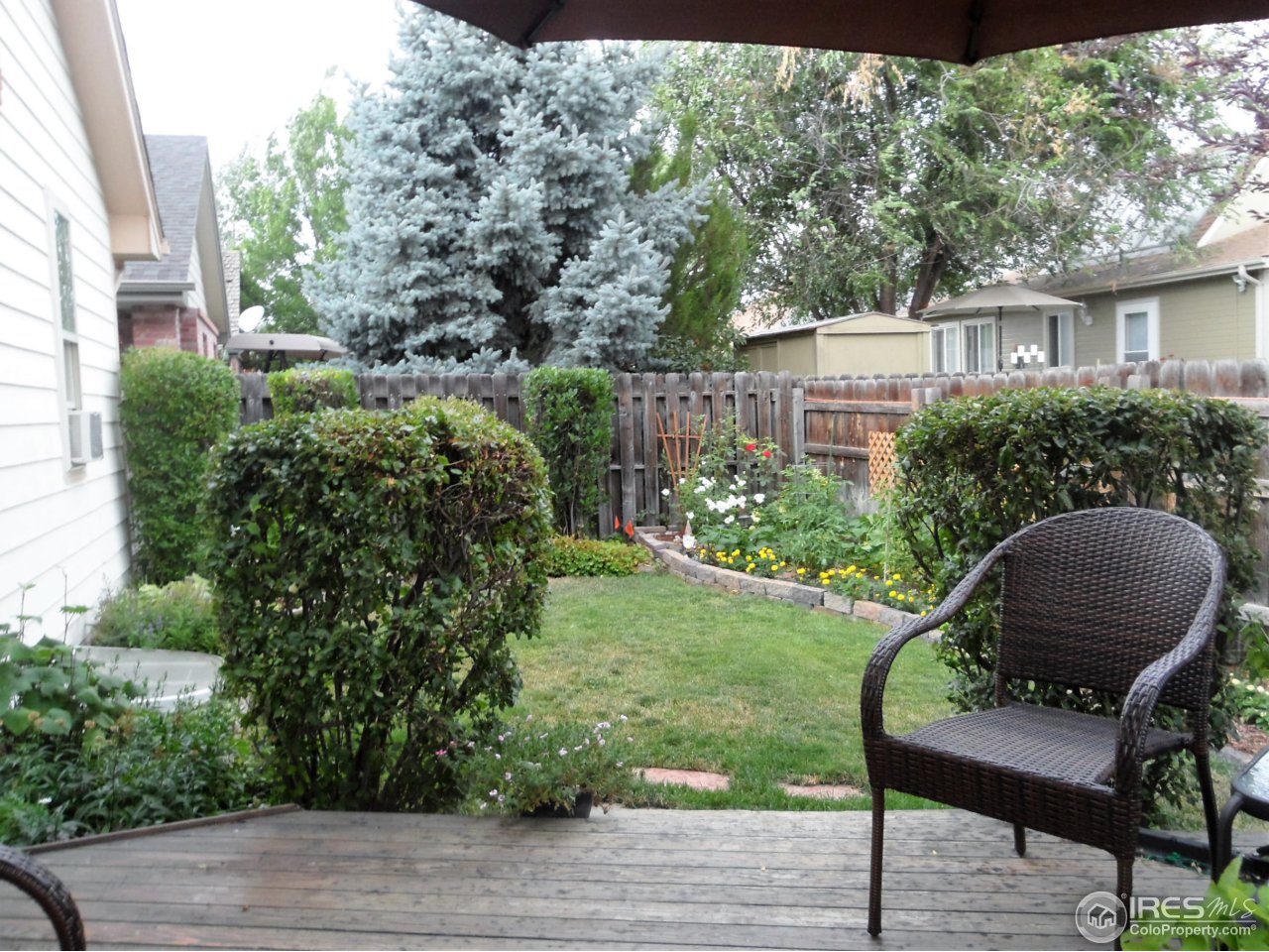 724 Wade Road Longmont, CO 80503 - Photo 32 of 32 a view of backyard with deck and garden