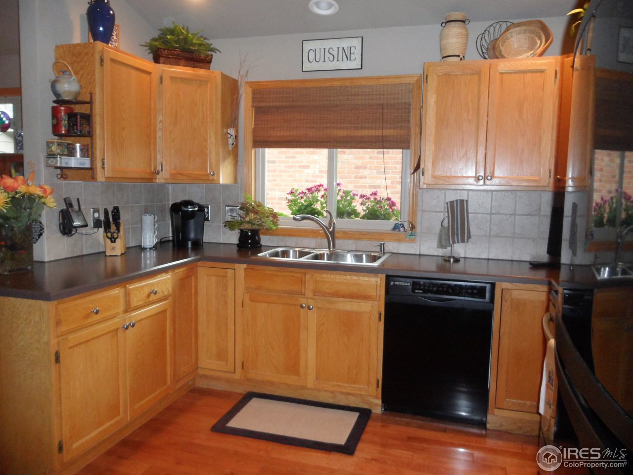 724 Wade Road Longmont, CO 80503 - Photo 4 of 32 a kitchen with stainless steel appliances granite countertop a sink a stove and a refrigerator